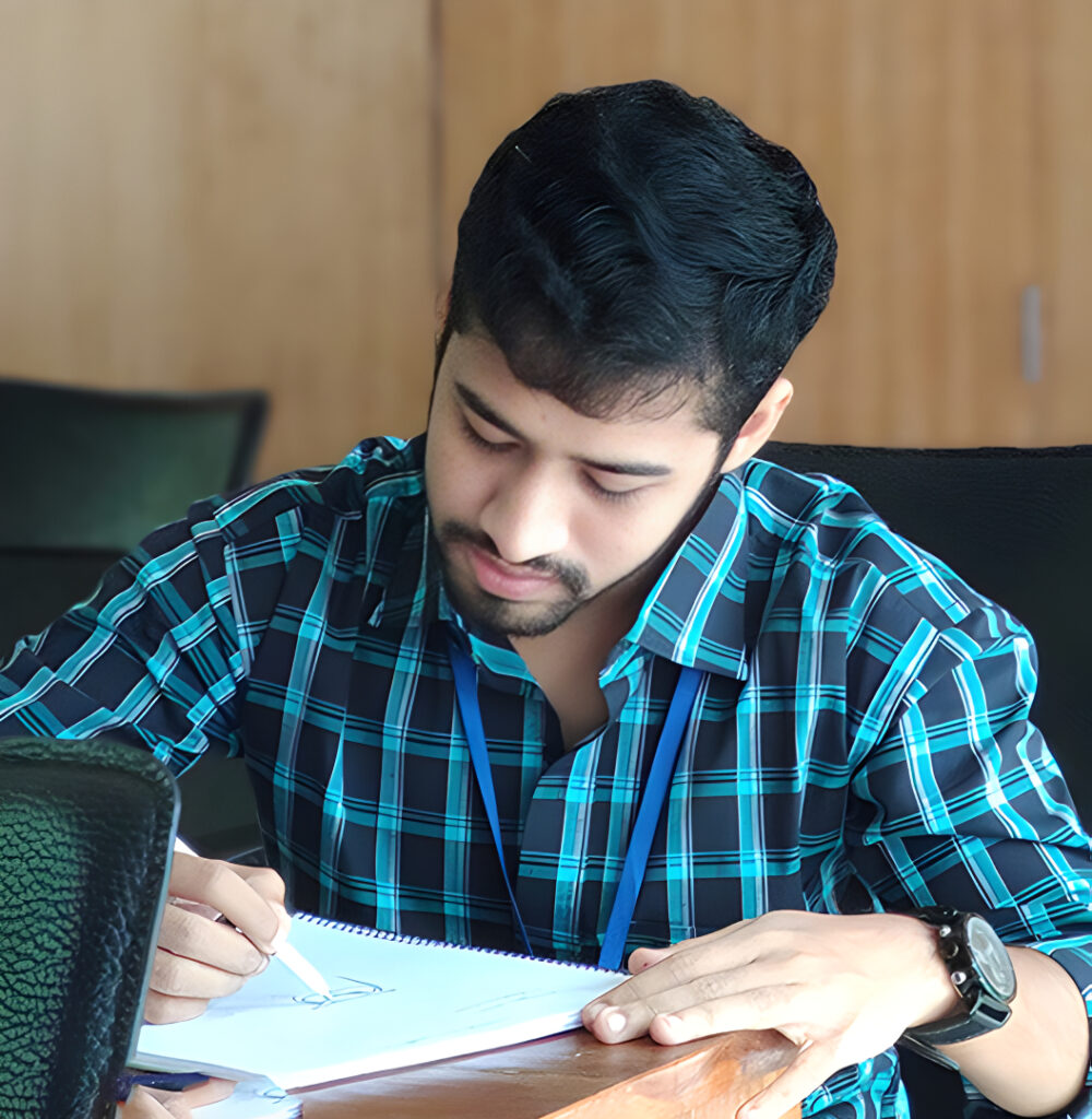 Sajal Mahmud sketching ideas at his desk